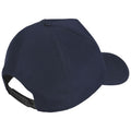 A navy blue cap is positioned backward displaying its curved brim and adjustable strap at the rear against a neutral background indicating it is intended for casual outdoor wear.