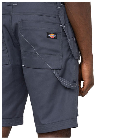 A person is wearing dark gray cargo shorts with multiple pockets and visible stitching details. Their right hand is partially visible, resting near the side of one pocket.