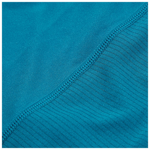 A piece of fabric in a vibrant teal color displays two different textures with a smooth section transitioning to a ribbed section along the edge showcasing careful stitching for durability.