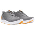 Gray athletic shoes with orange accents are positioned side by side showcasing a textured upper surface laced up for secure wear highlighting a sporty design suitable for running or training.