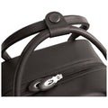 A black bag with a smooth surface is shown resting on a flat surface featuring a round handle secured with a button next to a zippered opening.