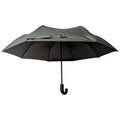 A dark umbrella stands upright with a curved hook handle beneath a broad canopy that is slightly elevated showcasing its textured fabric and structured ribs ideal for protection against rain or sun.