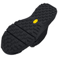 A black rubber shoe sole features a textured surface with various patterns for grip and traction showing a yellow Vibram logo on the side indicating durability and performance capabilities