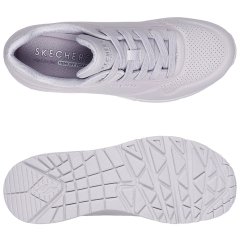 A white sneaker with a sleek design showcases a textured upper and a cushioned insole labeled with the brand Skechers and the phrase Air Cooled MEMORY FOAM on a plain background.