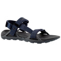 A navy blue sandal features adjustable straps made of woven material with a textured black sole designed for traction suitable for outdoor activities placed against a white background.