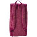 A pink backpack stands upright with two padded shoulder straps and a top handle. The fabric has a textured appearance, and the logo is subtly embroidered in gold on the front.