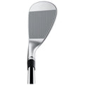 A golf club head is positioned upright displaying its flat striking surface and grooves designed for grip while preparing for a swing on a golf course.