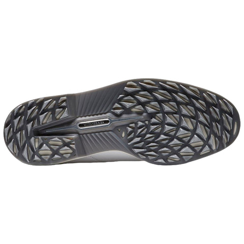 A shoe's sole featuring a textured grip pattern designed for traction on surfaces lies flat. The environment suggests an indoor or outdoor active setting suitable for various sports or activities.