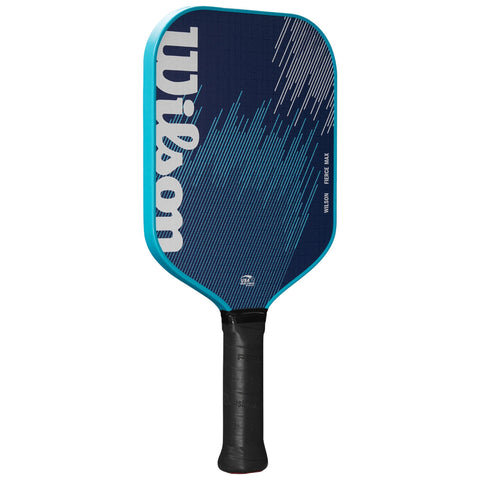 A pickleball paddle is prominently displayed. It features a navy blue surface with graphic lines and the word Wilson. The handle is black with a textured grip.