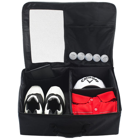 A black golf travel bag is open revealing organized compartments with white golf shoes in one section red polo shirts and a white Callaway cap in another section and several golf balls above.