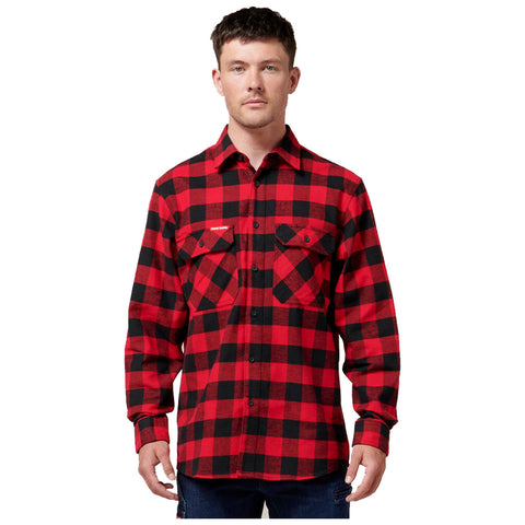 A man stands wearing a red and black plaid flannel shirt with buttoned pockets in a neutral background, presenting a casual and rugged appearance.