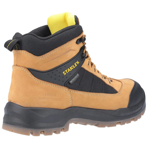 A brown and black waterproof boot stands upright with a textured sole and yellow accents at the collar and logo indicating brand and waterproof feature suitable for rugged outdoor use.