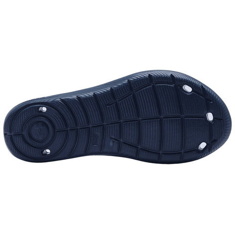 A dark blue shoe sole with textured patterns and circular indentations is displayed facing upward showcasing its design and traction features suitable for movement on various surfaces.