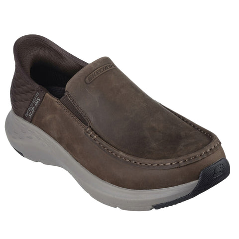 A brown slip-on shoe is positioned with a rounded toe and textured side panels showcasing a cushioned sole designed for comfort and ease in casual environments.