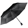 A black umbrella is open and positioned upside down showcasing its canopy and ribs in a stationary state. It is displayed against a neutral background highlighting its design and color.