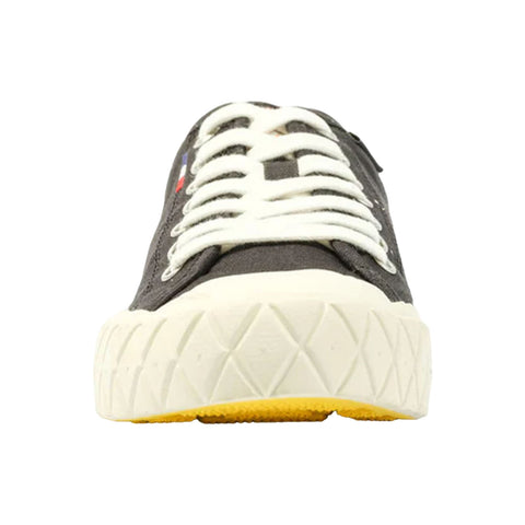 A black sneaker with white laces is positioned upright highlighting its textured sole and a pop of yellow at the bottom with red and blue details on the side.