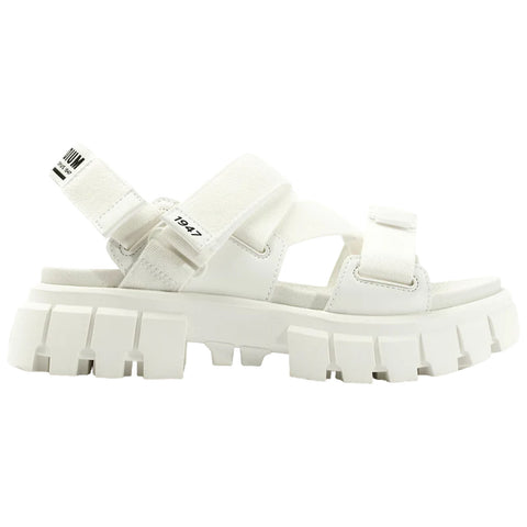 A white sporty sandal features thick soles with a rugged design and adjustable straps. It's displayed against a plain background emphasizing its minimalist style and modern aesthetic.