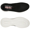 A black slip-on shoe with a textured upper rests flat showcasing its white rubber sole The insole features branding with the words Skechers Slip-ins and Air Cooled Memory Foam