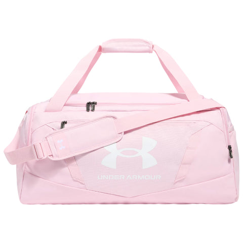 A pink duffel bag is displayed with a prominent white Under Armour logo on the side featuring dual handles and an adjustable shoulder strap positioned on a plain background.