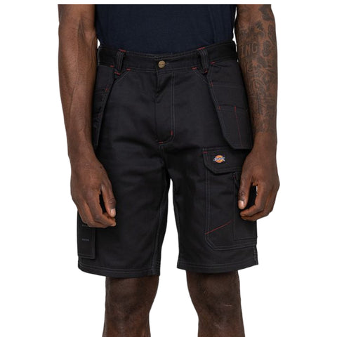 Black work shorts are worn by a person standing with hands at the sides pockets are visible with contrasting red stitching in a neutral background