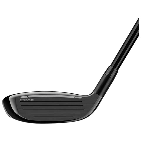 A black golf club head with a flat face and textured grooves is positioned sideways displaying the branding "TWIST FACE" emphasizing its sleek design within a blank white background.