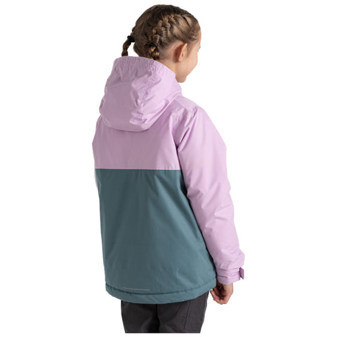 A child is wearing a color-blocked jacket with a pink upper section and a teal lower section while facing away in a bright, plain background.