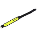 A neon yellow reflective wristband lies flat showcasing its velcro fastening and branding while designed for visibility in low-light contexts such as running or cycling at night.