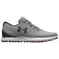 A grey athletic shoe features a textured upper with perforations and a black logo. It has a cushioned sole with visible traction studs, suitable for outdoor sports activities.