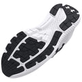 A black and white athletic shoe sole lies flat showcasing its textured gripping surface and various patterns designed for traction in sports or running environments.