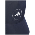 A navy blue cap features a circular logo with three stripes and text stating "ADIDAS GOLF THE BRAND WITH 3 STRIPES" on the front, displayed against a smooth fabric background.