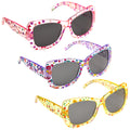 Three pairs of colorful flower-patterned sunglasses are displayed with dark lenses and angular frames resting together against a plain backdrop emphasizing their playful design and vibrant colors.