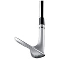 A golf wedge is positioned with its sharp edge facing slightly upward suggesting readiness for play showcasing a sleek metallic finish with engraved details and a black grip on the shaft.