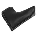 A black leather shoe horn is positioned at an angle showcasing its smooth surface and textured appearance with white stitching along the edge placed on a neutral background.