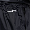 A black fabric garment displays the logo CRAGHOPPERS prominently while featuring a zippered pocket that suggests functionality and utility in an outdoor or casual setting.