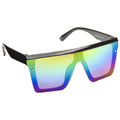 Colorful sunglasses with a prominent flat design reflect shades of blue green and yellow resting against a white background showcasing their vibrant lenses and bold style.