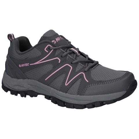 A gray hiking shoe with pink accents features a mesh and synthetic upper with textured patterns and a rugged black sole designed for traction in outdoor environments.