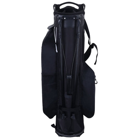 A black golf bag stands upright featuring four legs for stability has several pockets and a top opening designed for holding golf clubs in a casual setting.