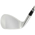 A golf club head with a polished silver face and grooves is positioned at an angle showcasing its design and surface texture against a plain background.