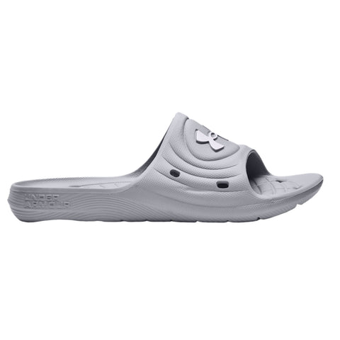 A grey slide sandal rests on a flat surface featuring a wide opening for the foot and a textured footbed with ventilation holes for comfort and breathability