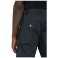 Black cargo pants with red stitching are being worn by a person showing the back view highlighting pockets and a branded metal button in a likely fashion context.