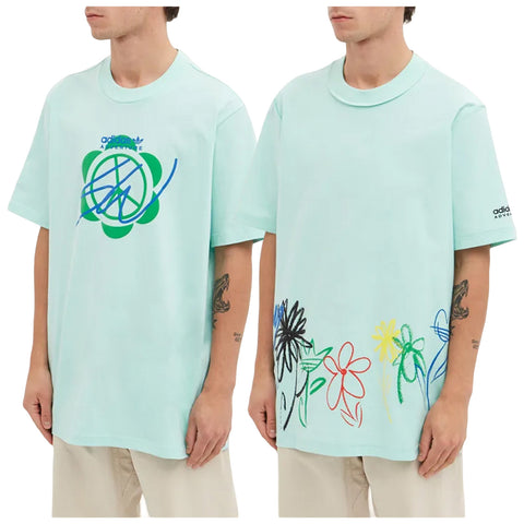 A mint green oversized t-shirt features colorful abstract designs on both sides with blue and green graphics on the front and floral sketches in various colors along the bottom.