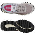 A gray athletic shoe is positioned with the sole visible and the laces tied the shoe features a textured upper and a rugged outsole designed for traction in various environments.