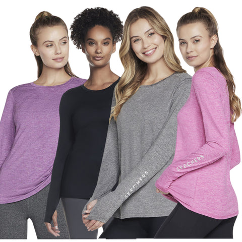 Four women wear long-sleeve shirts in different colors purple black gray and pink featuring a logo. They stand close together showcasing a variety of casual athletic fashion styles.