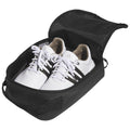 White athletic shoes with black stripes are neatly placed inside a black carrying bag that is partially unzipped revealing the shoes inside in a clean and organized manner.