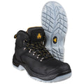 Black work boots with yellow accents are positioned upright with one boot in front of the other showcasing a rugged sole designed for traction on various surfaces.