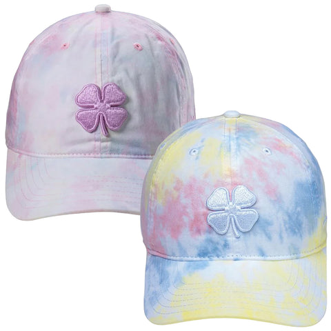 Two colorful tie-dye baseball caps are displayed side by side featuring four-leaf clover designs in contrasting colors on the front with soft pastel shades dominating the fabric