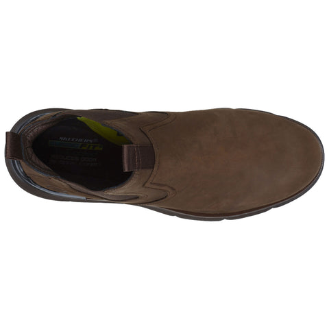 A brown slip-on shoe is displayed with a smooth upper surface and elastic side panels suggesting comfortable wear while a contrasting interior reflects a casual style