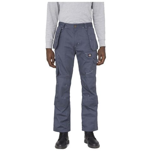 Dark gray cargo pants are being worn by a person with black boots standing in front of a neutral background. The pants feature multiple pockets and visible stitching details.