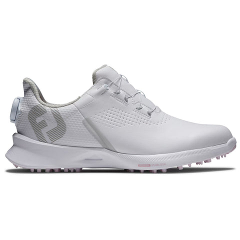 A white athletic shoe with a textured design and light gray accents is positioned on a flat surface showcasing its low profile and spiked outsole for traction during sports activities.