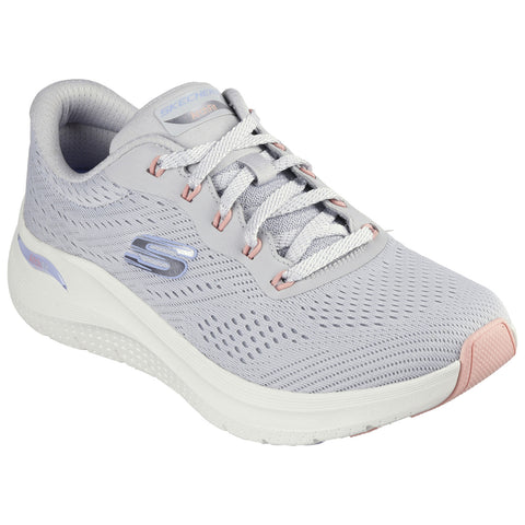 A light gray athletic shoe with mesh upper and subtle pink accents rests on a flat surface showcasing its breathable design and flexible sole suitable for active use.